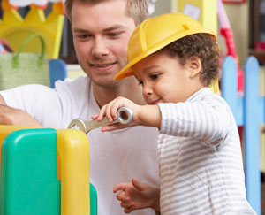 man and a child playing together, building, wearing construction hat